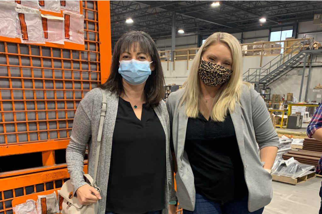 Lynn and Jenny wearing matching tops in the Maglin plant