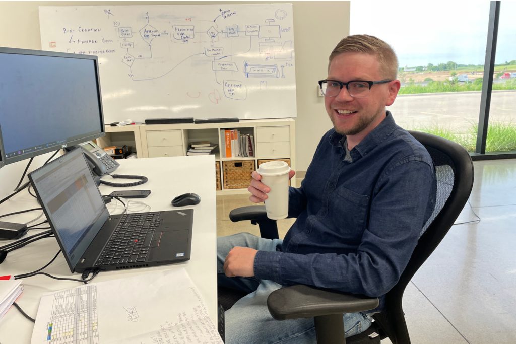 Oskar enjoying a coffee while working at his desk