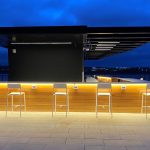 Foro Bar Height Stools powdercoated white next to bar on roof top patio