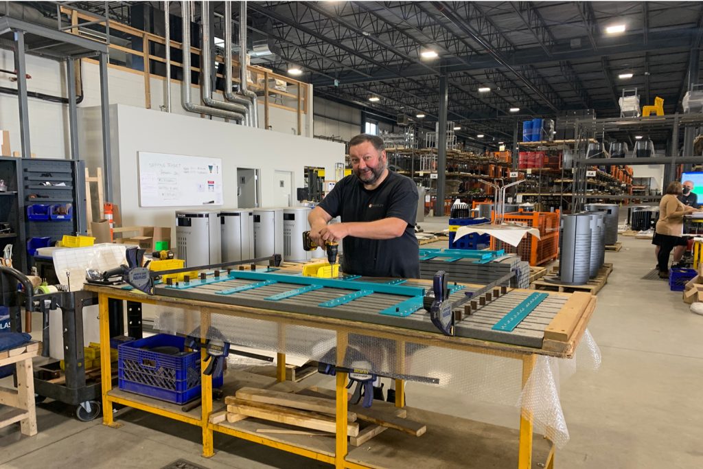 Man assembling cluster seating table in Maglin plant