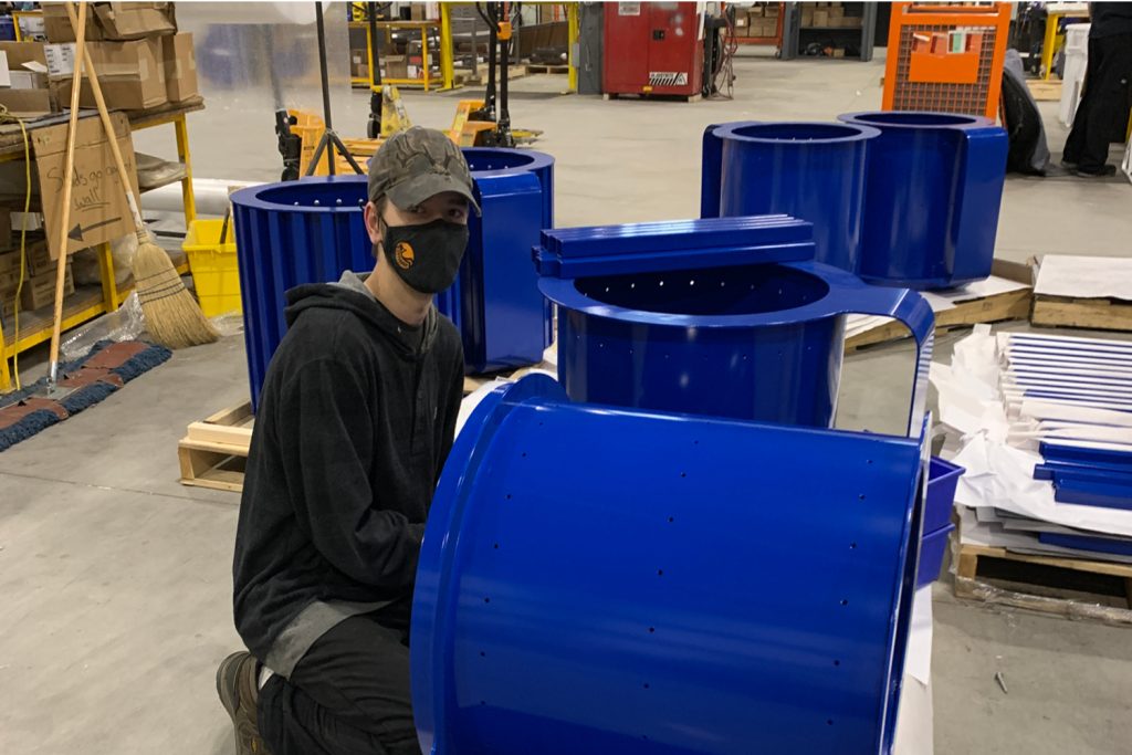 Maglin employee assembling some MUG planters