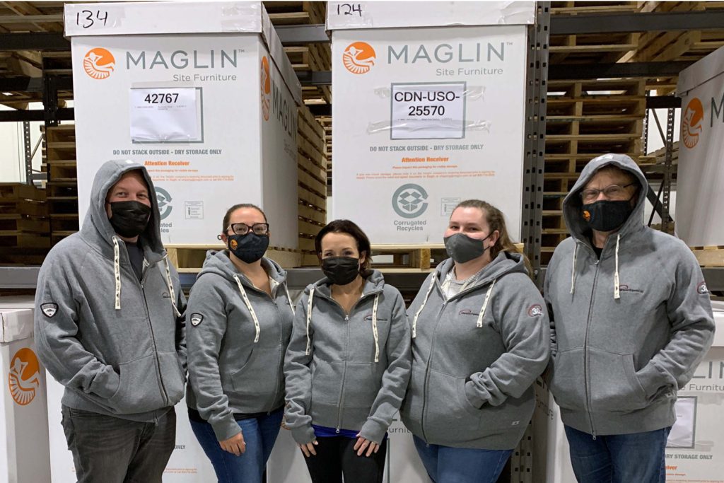 Aaron, Erin, Sarah, Trish and Ian wearing matching hoodies in the plant