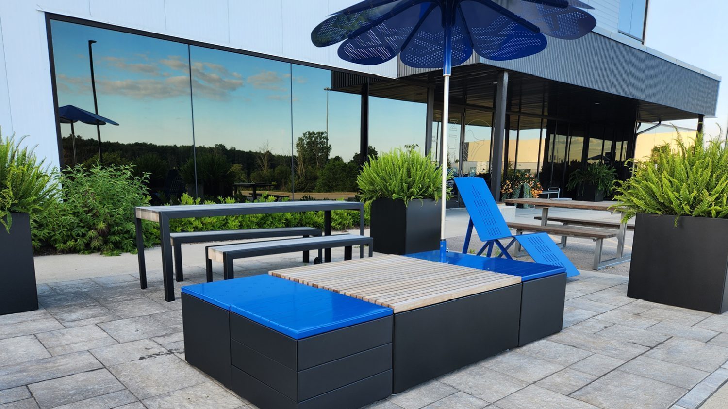 Maglin head office patio with Pixel blocks and ROMA Sun Shade, building, greenery