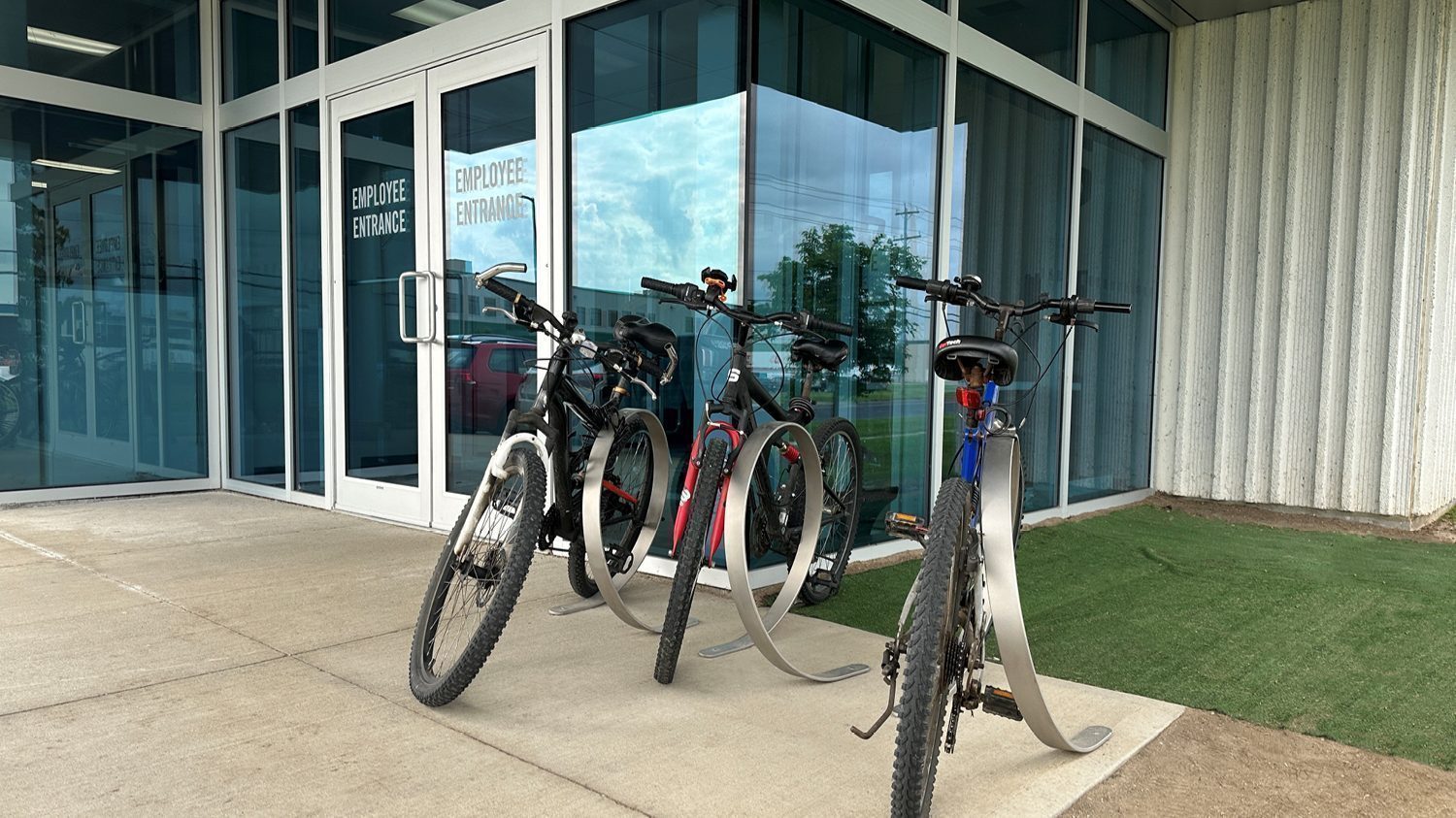 Orbit Bike Racks with bikes locked in front of glass entrance