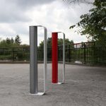 Gunmetal, white and red MUG Bike Racks on a school campus