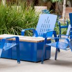 ALUM Lounge Chairs painted gloss blue with Pixel table blocks on a patio with greenery