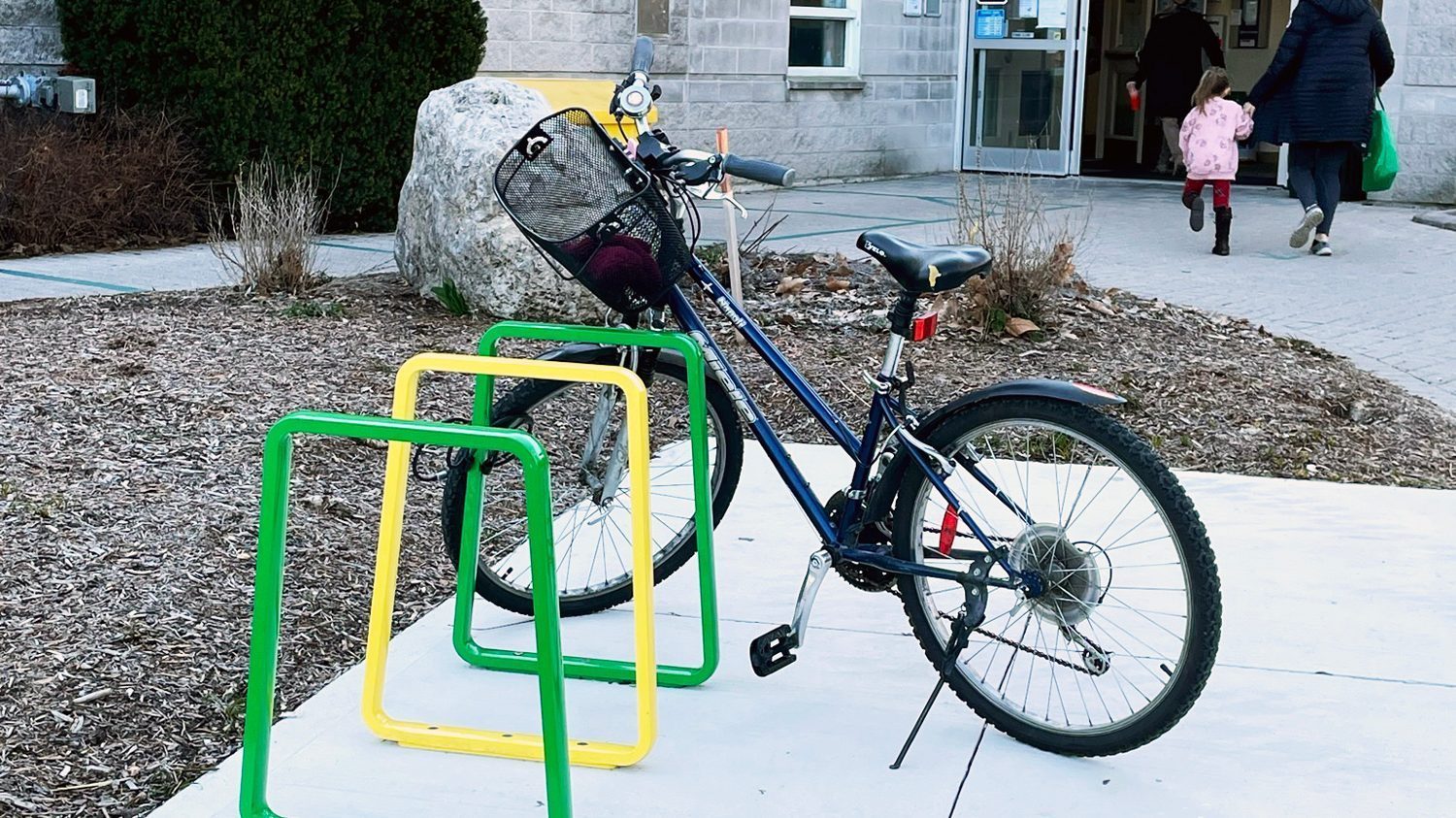 Brightly painted Iconic Bike Racks with bike secured at community center