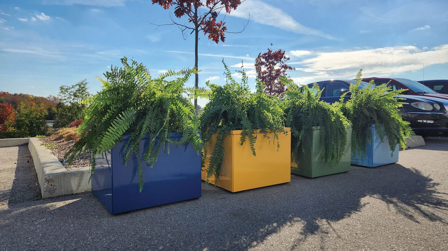 Pixel planters painted in mellow powdercoat colors with blue skies