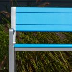 Backed 970 Bench with High Density Polyethylene seat and back in blue, with grasses in background