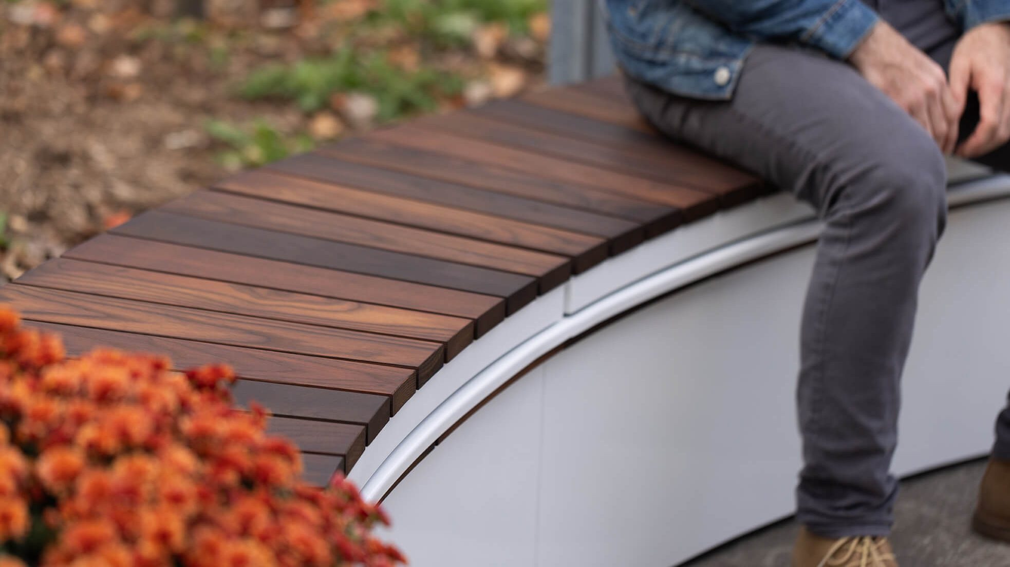 Curved Ogden Bench on CANOE modular planter with man sitting