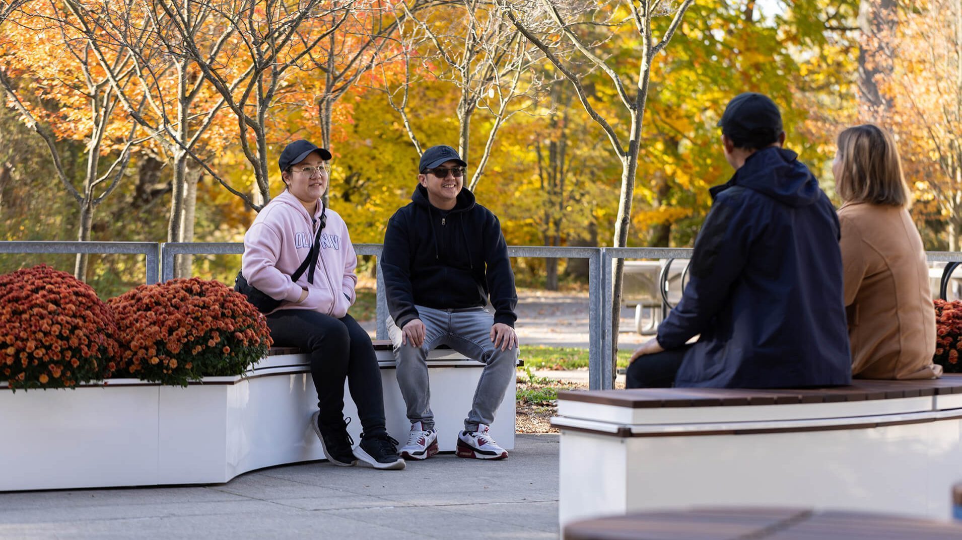 Fall day with people sitting on CANOE modular planters