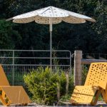 ROMA Sun Shade with ALUM Chaise Lounge chairs in scenic location surrounded by trees and greenery